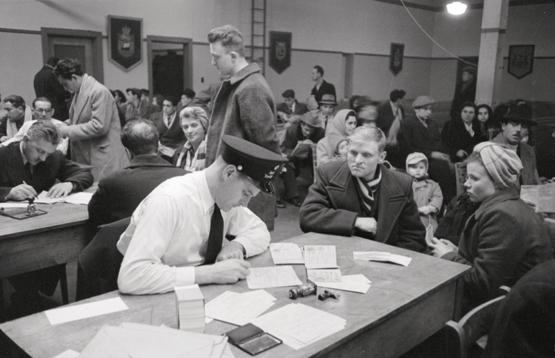 Chris Lund, Examining new arrivals in Immigration Examination Hall, Pier 21, Halifax, March 1952